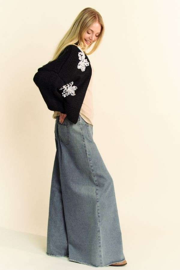 Side view showing roomy sleeves and cropped fit