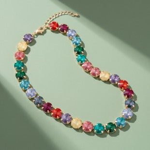 Rainbow jewel tone necklace styled on green background